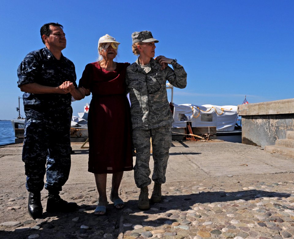 US Navy 110420-F-ET173-134 Hospital Corpsman 3rd Class Ricardo Ramirez and Air Force Capt. Tanya Yelverton, a medical administrator, walk a patient