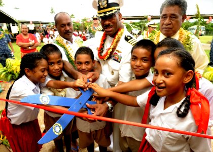 US Navy 110418-N-YM863-383 Capt. Jesse Wilson, mission commander of Pacific Partnership 2011, cuts the ribbon during a re-opening ceremony for a go