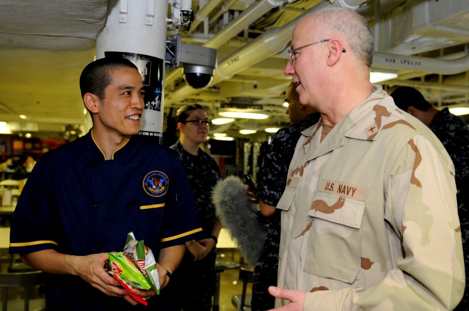 US Navy 110416-N-8040H-341 Rear Adm. Mark L. Tidd, chief of chaplains, speaks with Culinary Specialist 2nd Class Hawk Ivie on the aft mess decks