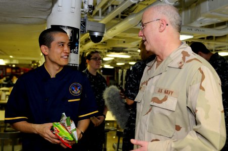 US Navy 110416-N-8040H-341 Rear Adm. Mark L. Tidd, chief of chaplains, speaks with Culinary Specialist 2nd Class Hawk Ivie on the aft mess decks