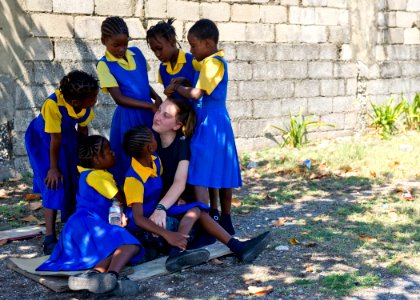 US Navy 110419-N-RM525-323 School children gather around Hospital Corpsman 3rd Class Jennifer Munehing, from Beaufort, S.C photo