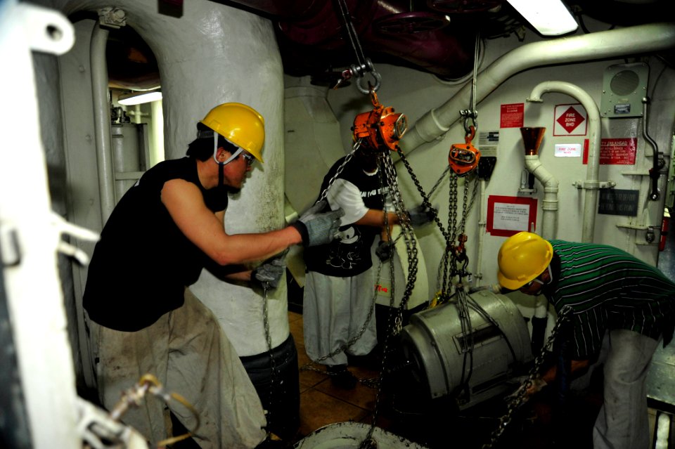 US Navy 110416-N-VL413-001 Japanese civilian shipyard workers aboard the nuclear-powered aircraft carrier USS George Washington (CVN 73) move a mot