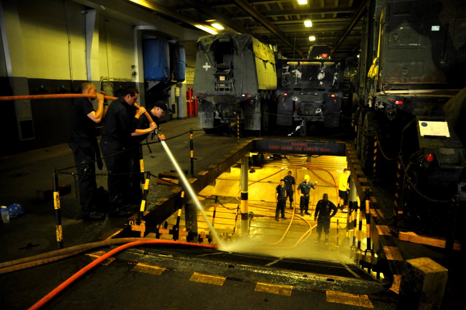 US Navy 110422-N-7293M-097 Seaman Andrew Myers, left, Airman Apprentice Andrew Meade and Seaman Apprentice Jacob Gibson wash the ramp of the upper