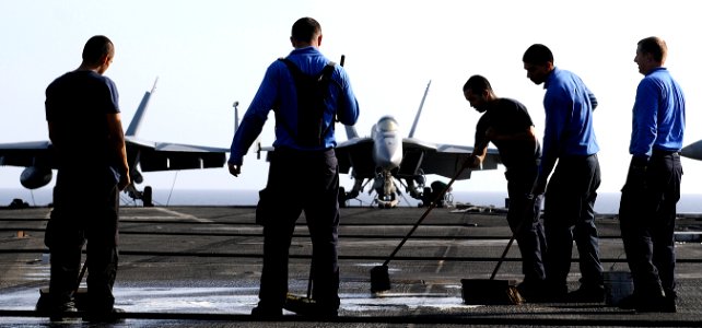 US Navy 110422-N-8040H-468 Sailors assigned to the air department scrub down the flight deck of the Nimitz-class aircraft carrier USS Carl Vinson (