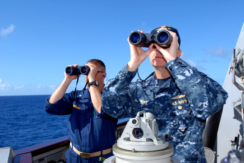 US Navy 110422-N-ZI300-040 Cmdr. Christopher Nerad, executive officer of the guided-missile destroyer USS Nitze (DDG 94), and Capt. Marc Weeks, com