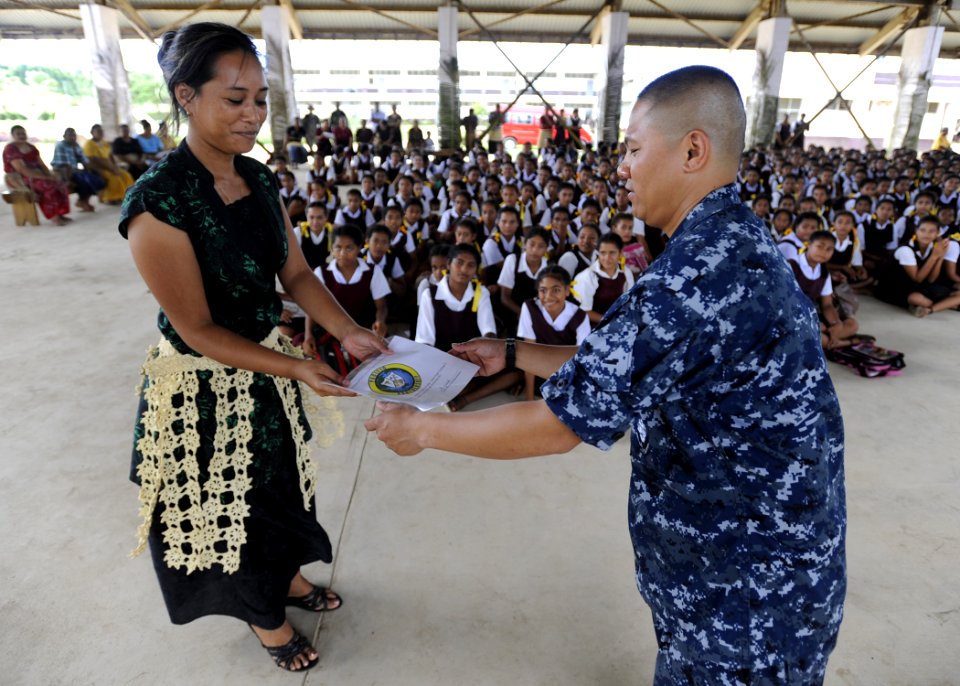 US Navy 110419-N-YM863-069 Lt. Jay Zulueta hands out a certificate of attendance to a parent who attended a CPR class during a Pacific Partnership