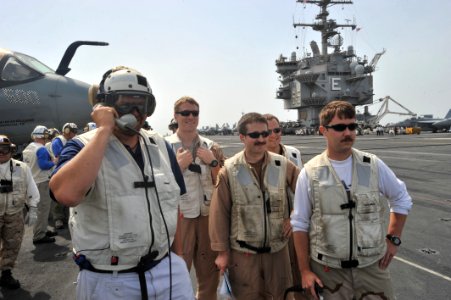 US Navy 110423-N-0569K-002 Country music performer Toby Keith talks to an approaching pilot from the landing signal officer platform aboard the air