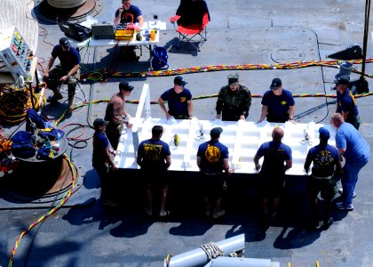 US Navy 110420-N-3154P-283 Sailors assigned to Mobile Diving and Salvage Unit (MDSU) 2 move a coffer dam on the deck of Military Sealift Command re