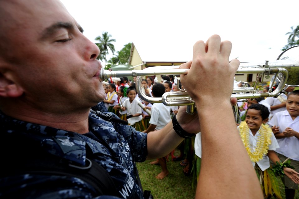 US Navy 110418-N-YM863-803 Musician 1st Class John Wheeler performs during a re-opening ceremony for a government primary school during a Pacific P