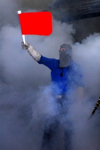 US Navy 110423-N-SB672-003 Aviation Boatswain's Mate (Handling) Airman Justin Martin waves a flag signifying a fire during a mass casualty drill
