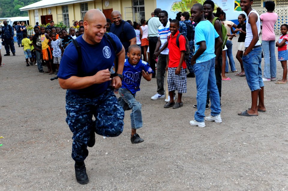 US Navy 110421-F-CF975-025 Hospital Corpsman 2nd Class Jasmin Copeland, from Chesapeake, Va., races a primary school student during a Continuing Pr
