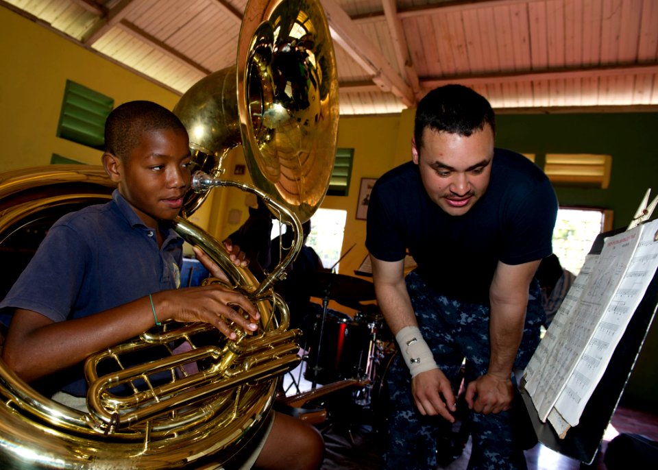 US Navy 110420-N-RM525-032 Musician 3rd Class Christopher Roland, from Atlus, Okla., gives a music lesson to a student