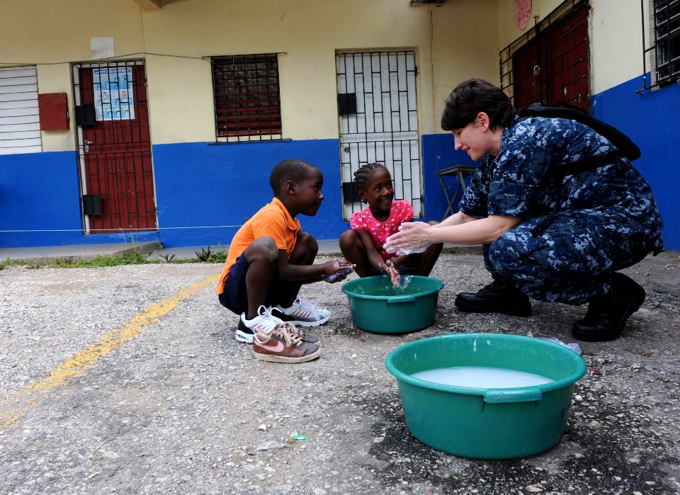 US Navy 110421-F-ET173-114 Lt. Danna Convoy, from Camp Lejeune, N.C., teaches children how to wash their hands during a Continuing Promise communit