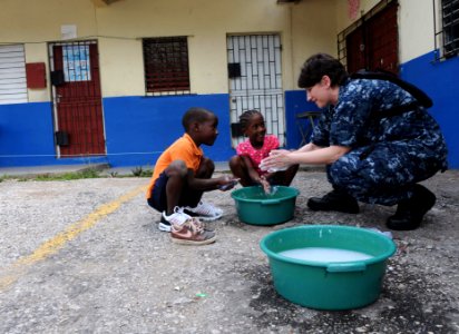 US Navy 110421-F-ET173-114 Lt. Danna Convoy, from Camp Lejeune, N.C., teaches children how to wash their hands during a Continuing Promise communit photo