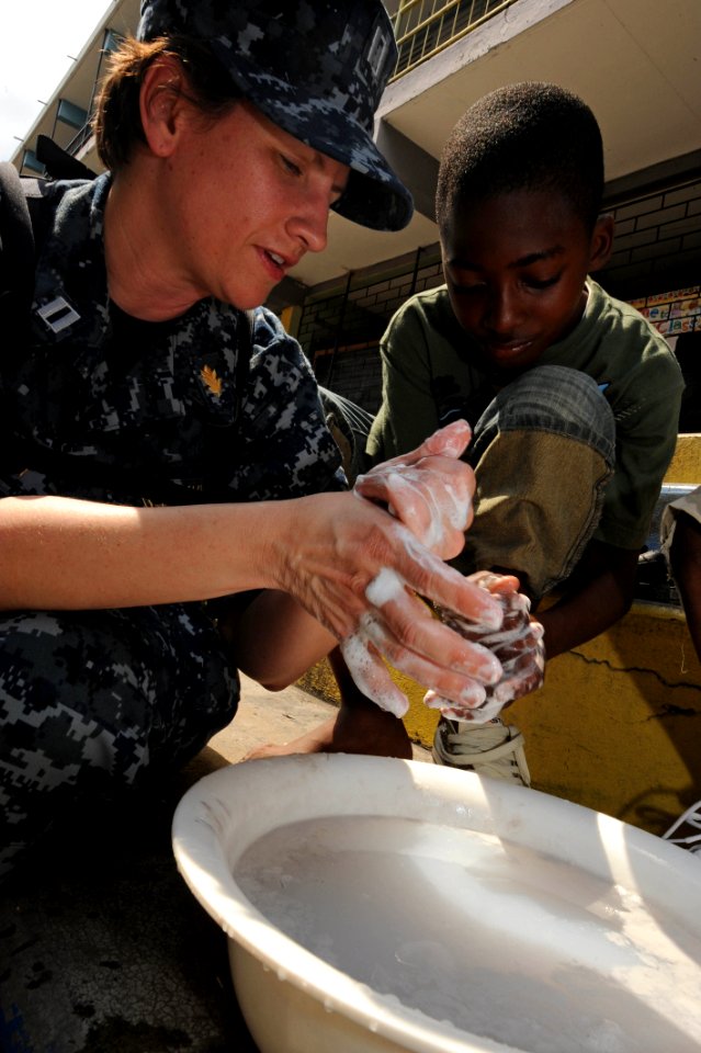 US Navy 110421-F-ET173-368 Lt. Danna Convoy, from Camp Lejeune, N.C., teaches a boy how to properly wash his hands during a Continuing Promise 2011