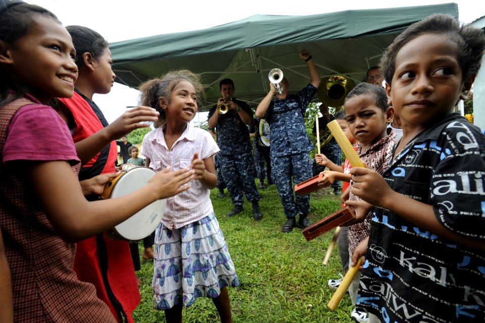 US Navy 110420-N-YM863-421 Children dance and play percussion instruments while the Pacific Partnership 2011 band performs during a ribbon cutting