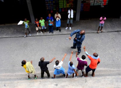 US Navy 110421-F-ET173-353 Aviation Support Equipment Technician 2nd Class Kevin Cobb entertains students with a game of Simon Says photo