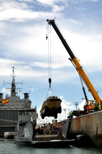US Navy 110423-N-7293M-550 A lighter amphibious resupply cargo is lifted by crane from Landing Craft Utility (LCU) 1661 to the pier for an agricult