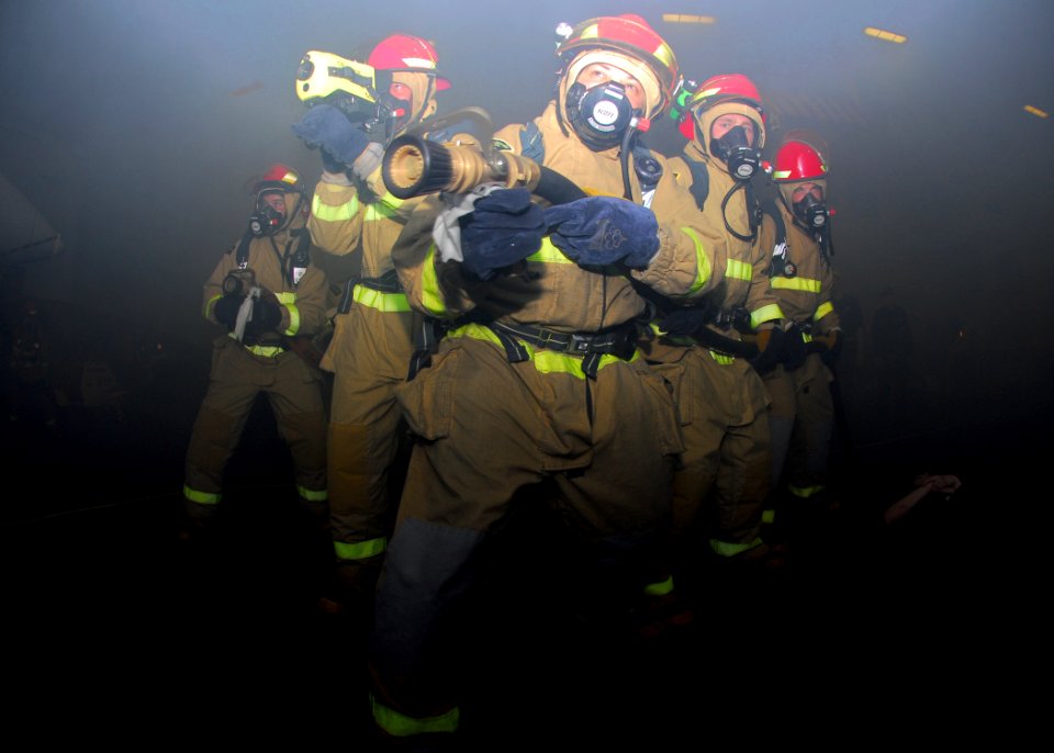 US Navy 110423-N-GL340-220 Sailors simulate fighting a fire during a mass casualty drill aboard the aircraft carrier USS Ronald Reagan (CVN 76)