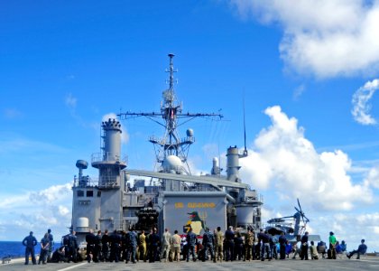 US Navy 110424-F-HS649-072 Sailors and Marines attend an Easter service on the flight deck of the amphibious transport dock ship USS Cleveland (LPD