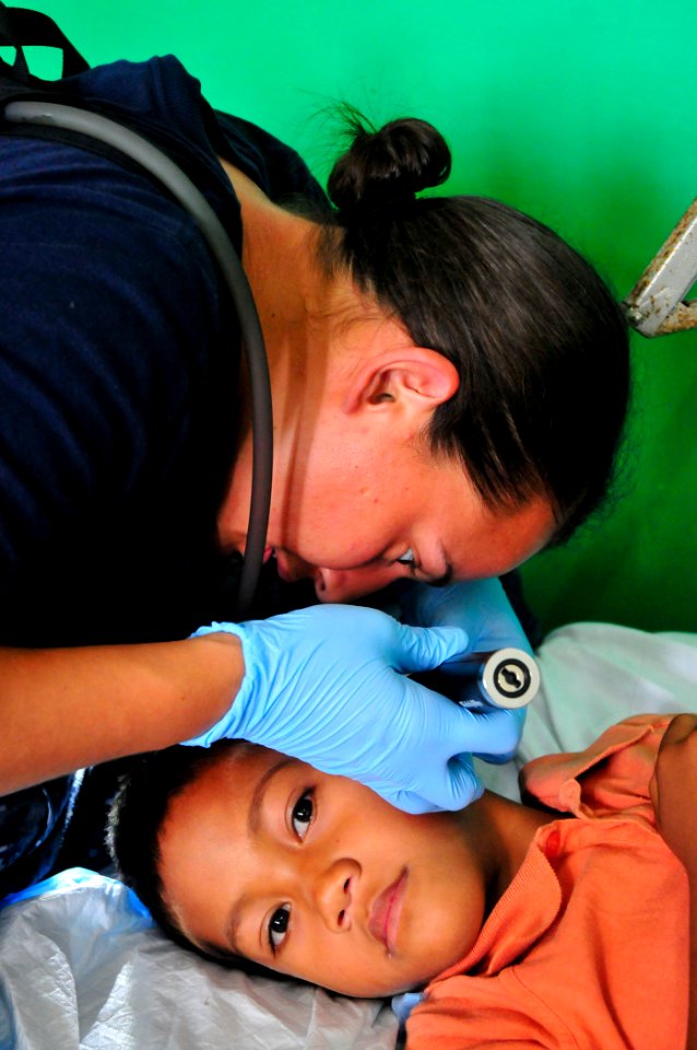 US Navy 110420-O-XX000-012 Aislinn Mangan, a registered nurse with Project Hope, tends to a patient during a Pacific Partnership 2011 medical commu
