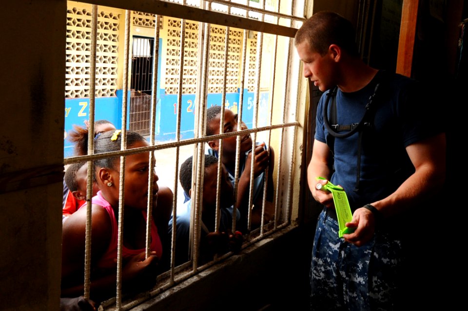 US Navy 110421-F-CF975-145 Aviation Electrician's Mate Airman Joshua Schell, from Baltimore, talks to neighborhood children during a Continuing Pro