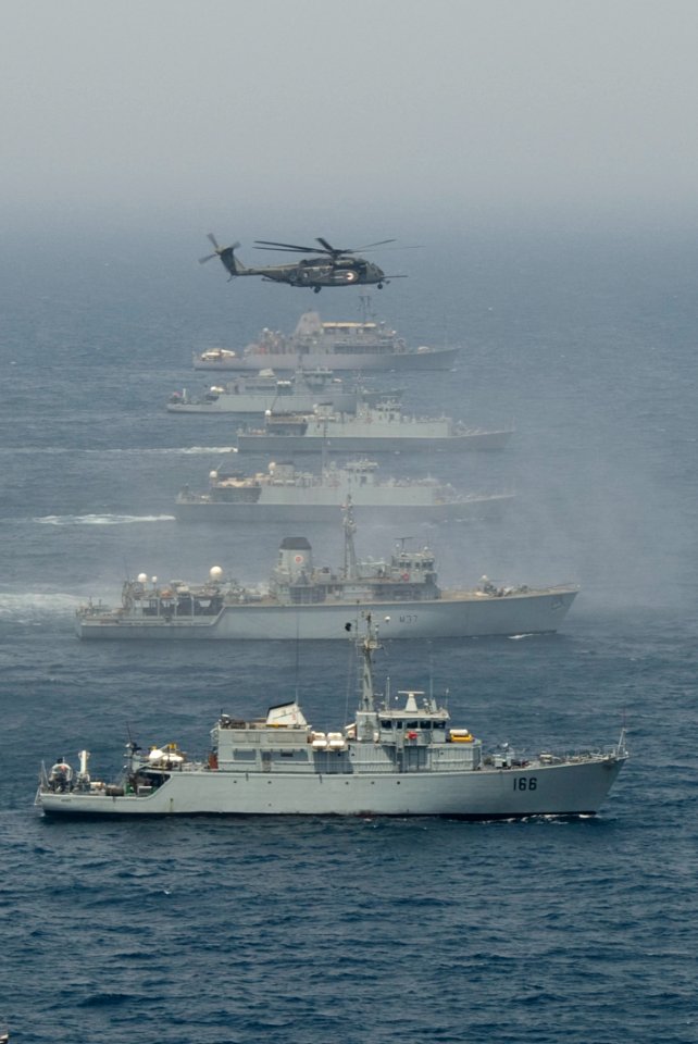 US Navy 110424-N-YX920-244 A CH-53 Sea Stallion helicopter flies in formation with British, Pakistani and U.S. mine countermeasures ships during Ar