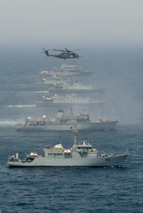 US Navy 110424-N-YX920-244 A CH-53 Sea Stallion helicopter flies in formation with British, Pakistani and U.S. mine countermeasures ships during Ar