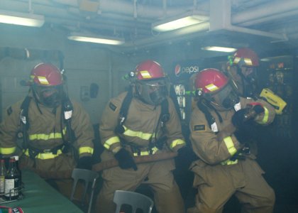 US Navy 110426-N-SG869-022 Sailors combat a simulated electrical fire during a general quarters drill on the mess decks aboard USS Ronald Reagan (C photo