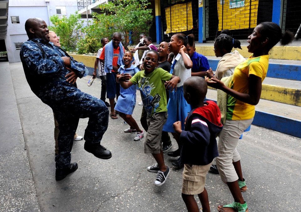 US Navy 110421-F-ET173-338 Aviation Support Equipment Technician 2nd Class Kevin Cobb entertains students with a game of Simon Says