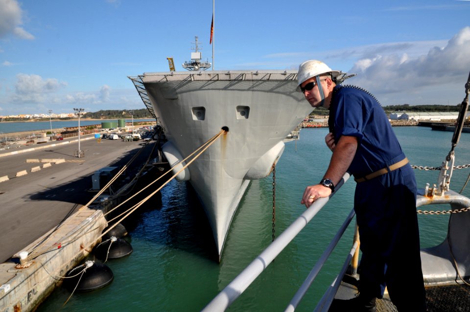 US Navy 110423-N-7293M-120 Chief Boatswain's Mate Robert Battles watches as USS Ponce (LPD 15) is pushed into its berth at Naval Base Rota, Spain