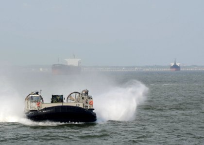 US Navy 110422-N-7680E-133 A landing craft air cushion (LCAC) approaches the multi-purpose amphibious assault ship USS Iwo Jima (LHD 7)