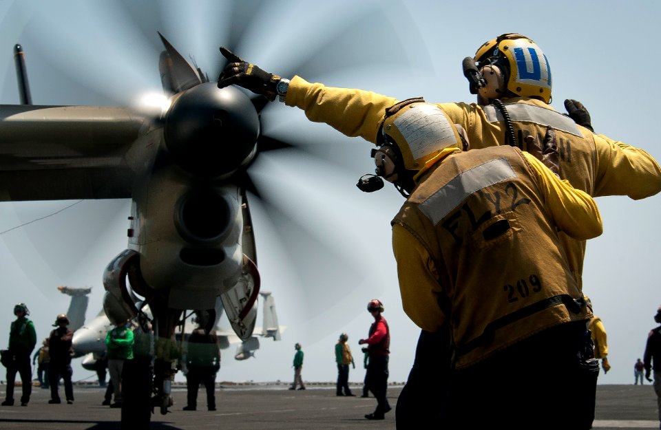 US Navy 110426-N-8040H-050 Aviation boatswain's mates (handling) direct an E-2C Hawkeye aboard the Nimitz-class aircraft carrier USS Carl Vinson (C