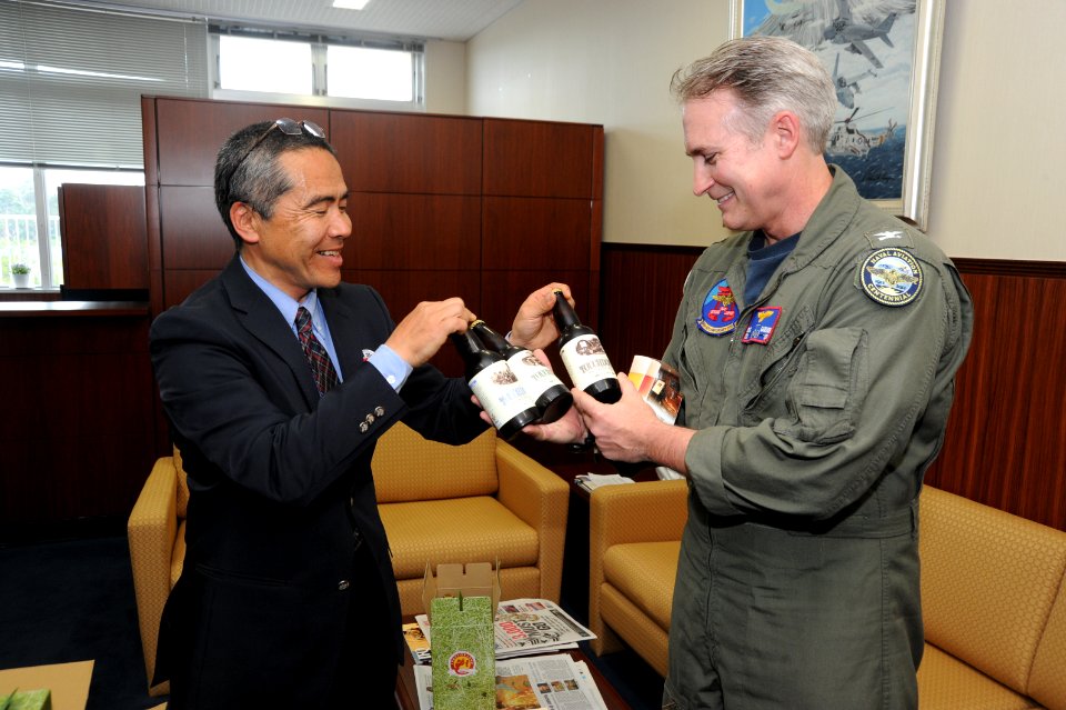 US Navy 110427-N-VE260-033 Ryo Funaki presents beer from Yatsugatake Brewery to Capt. Eric Gardener as a gift for the efforts of the Sailors and Ma