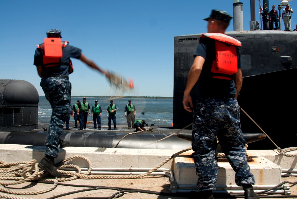 US Navy 110429-N-FG395-054 Seaman Andrew Burton, left, a line handler from the Blue crew of the guided-missile submarine USS Florida (SSGN 728), to