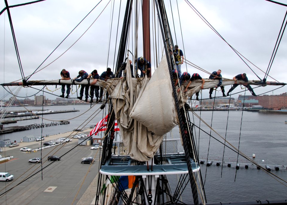 US Navy 110428-N-7642M-666 Sailors practice furling and unfurling a sail aboard USS Constitution for the first time since the ship began a restorat