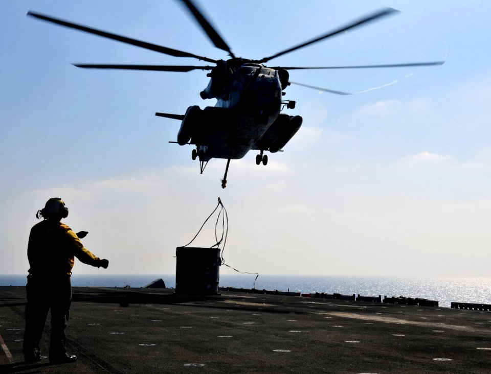 US Navy 110423-N-ZS026-084 viation Boatswain's Mate 3rd Class Rodolfo Lopez signals a CH-53 Sea Stallion helicopter assigned to the Evil Eyes of Ma