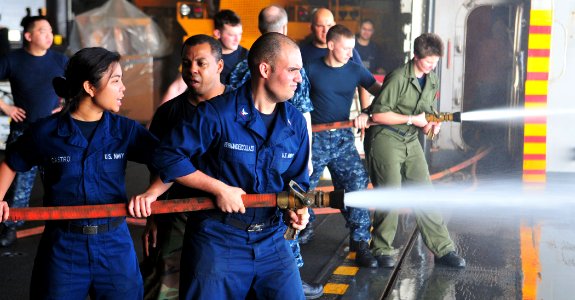 US Navy 110428-N-ZS026-049 Sailors practice fire hose handling techniques during damage control team training