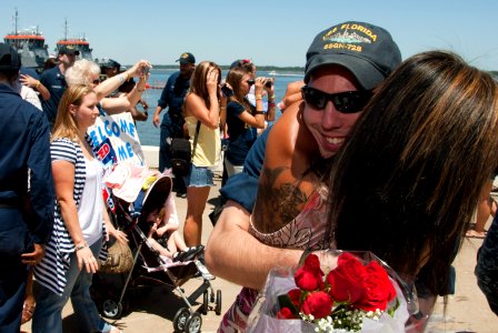 US Navy 110429-N-FG395-078 Machinist's Mate 2nd Class Aspen Serr is greeted by his wife during a homecoming celebration as the Ohio-class guided-mi