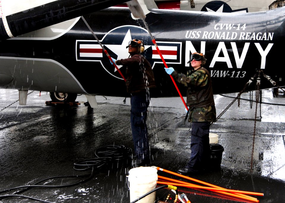 US Navy 110423-N-DM338-070 Sailors assigned to the Black Eagles of Airborne Early Warning Squadron (VAW) 113, scrub an E-2C Hawkeye aboard the airc