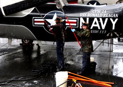 US Navy 110423-N-DM338-070 Sailors assigned to the Black Eagles of Airborne Early Warning Squadron (VAW) 113, scrub an E-2C Hawkeye aboard the airc