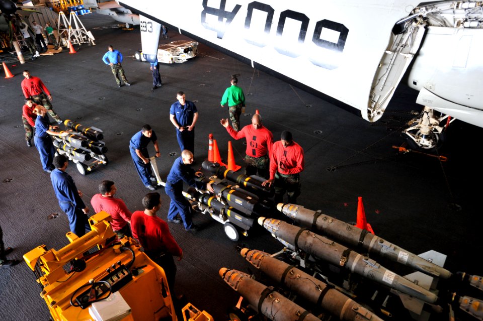 US Navy 110430-N-0569K-054 Sailors transport ordnance through the hangar bay aboard USS Enterprise (CVN 65)
