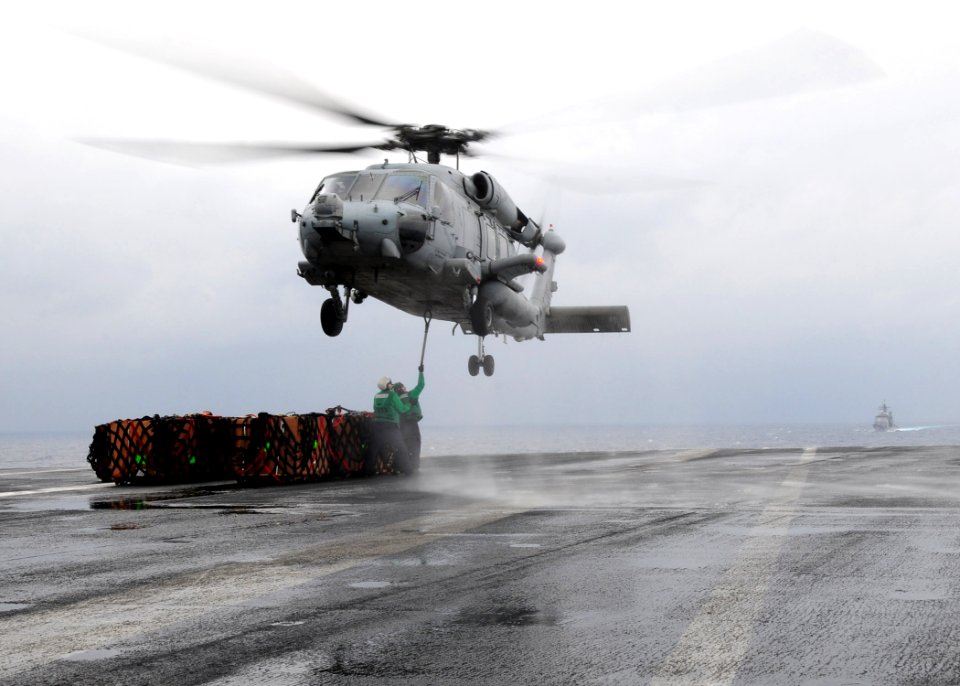 US Navy 110423-N-SG869-021 Logistics Specialist 3rd John Laughlin, from Hanford and Logistics Specialist 1st Class Kristopher Forest hook a load o