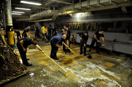 US Navy 110422-N-7293M-049 Sailors clean the deck of the lower vehicle storage bay aboard USS Ponce (LPD 15)