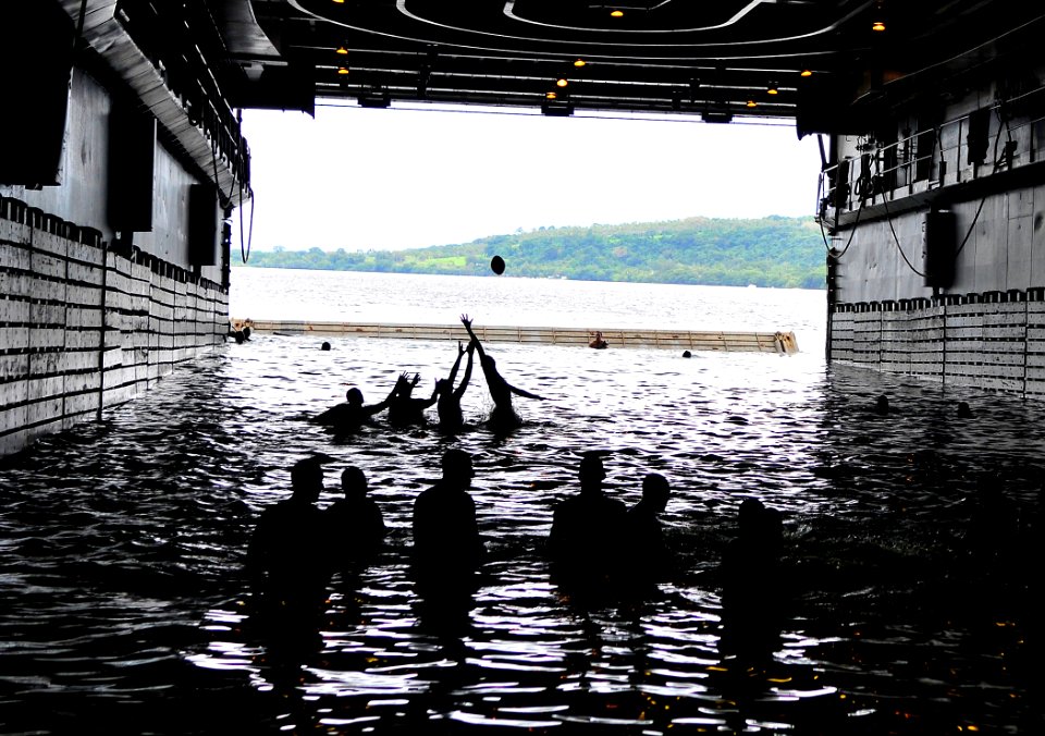 US Navy 110429-N-KB563-013 Sailors play football during a swim call in the well deck of the amphibious transport dock ship USS Cleveland (LPD 7)