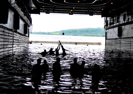 US Navy 110429-N-KB563-013 Sailors play football during a swim call in the well deck of the amphibious transport dock ship USS Cleveland (LPD 7)