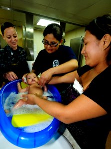 US Navy 110502-N-EP471-077 Sailors help a mother wash her son before a cleft lip surgery