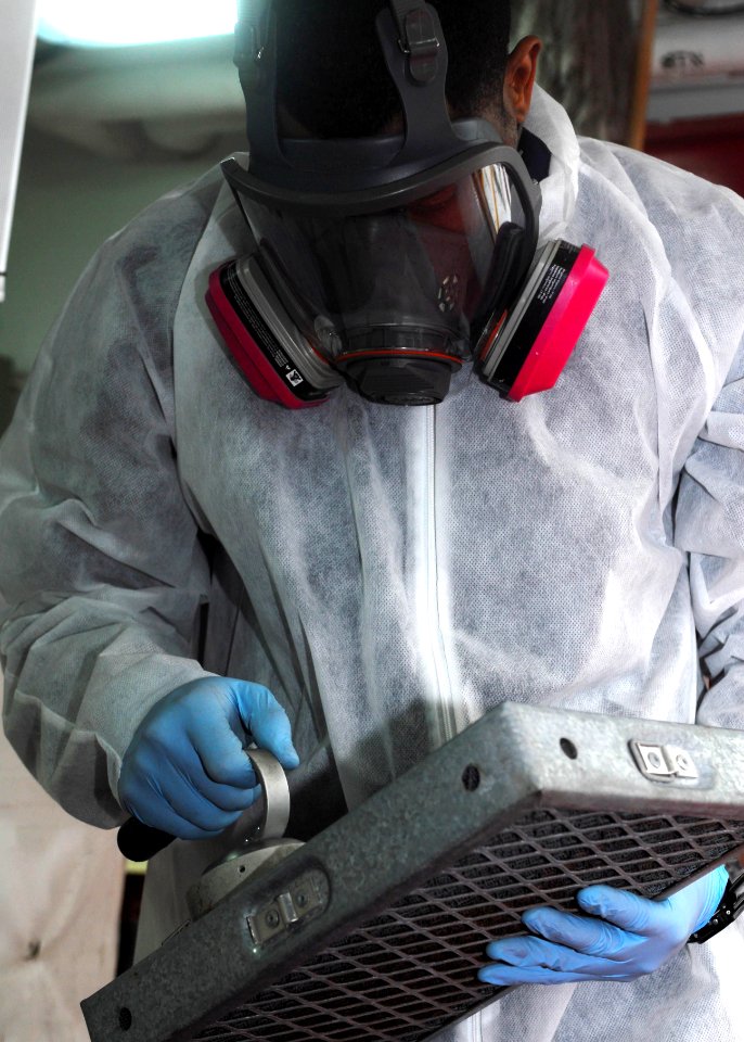 US Navy 110426-N-GL340-008 Damage Controlman 2nd Class Ronnie Parker, from Monterey, Calif., checks a ventilation filter for radiation aboard the a