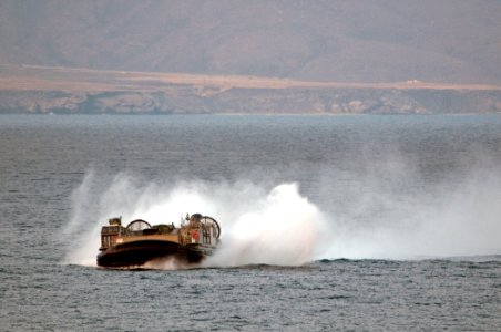 US Navy 110427-N-RC734-296 A landing craft air cushion (LCAC) assigned to Assault Craft Unit (ACU) 5 approaches the amphibious dock landing ship US