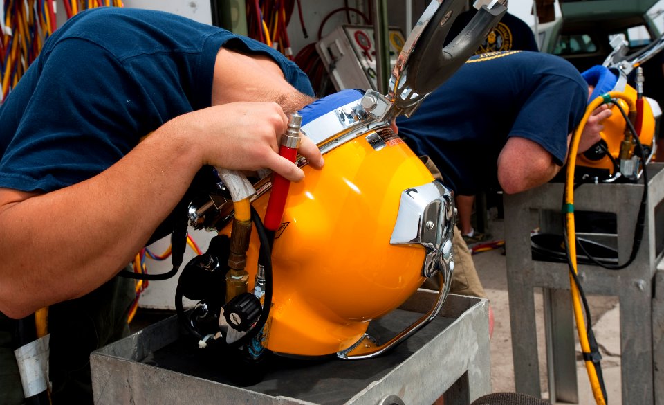 US Navy 110426-N-OT964-090 Navy Divers 2nd Class Troy Crowder, left, and Cody Creger test the voice communications inside of Kirby Morgan 37 diving
